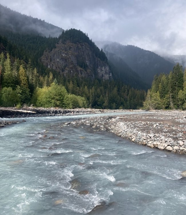 Water flowing down the White River with mountains in the background. Water flowing down the White River with mountains in the background.