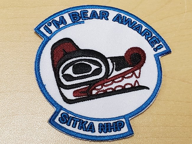 A patch with a Tlingit formline bear design and the words "I'm Bear Aware"