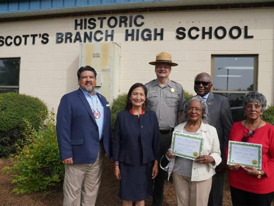 Secretary Deb Haaland's visit to Summerton, SC Three women and three men standing in front of a school
