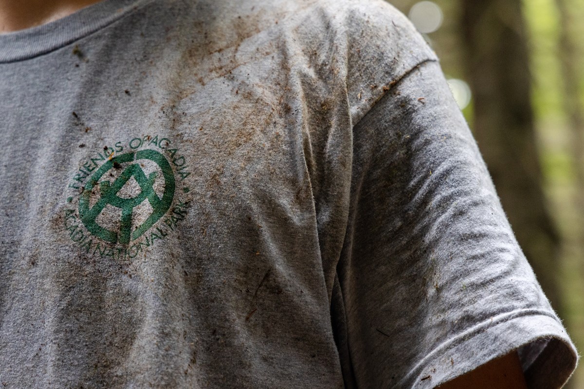 Close up of dirt ground into a worker's T-shirt