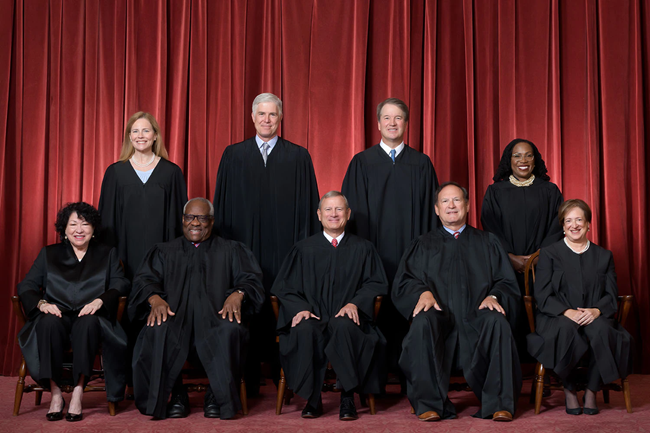 2022_Roberts_Court_Formal_083122_Web The Roberts Court Justices in front of a velvet curtain back drop