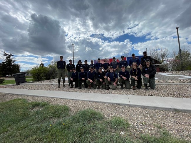 A large group of Alpine Firefighters stand outside for a group photo.