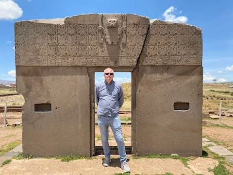 2023 NCPTT - Bolivia - Simeon at the Puerto De Sol_The Sun Gate Simeon Warren stands beneath a Bolivian stone entranceway.