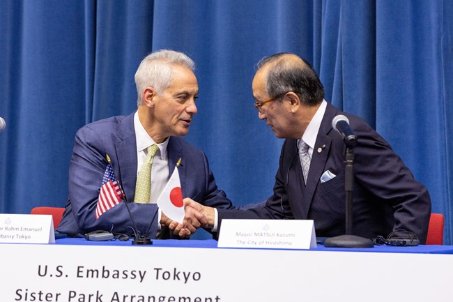2023 Pearl-Hiroshima The American and Japanese signatories shake hands after the signing ceremony.
