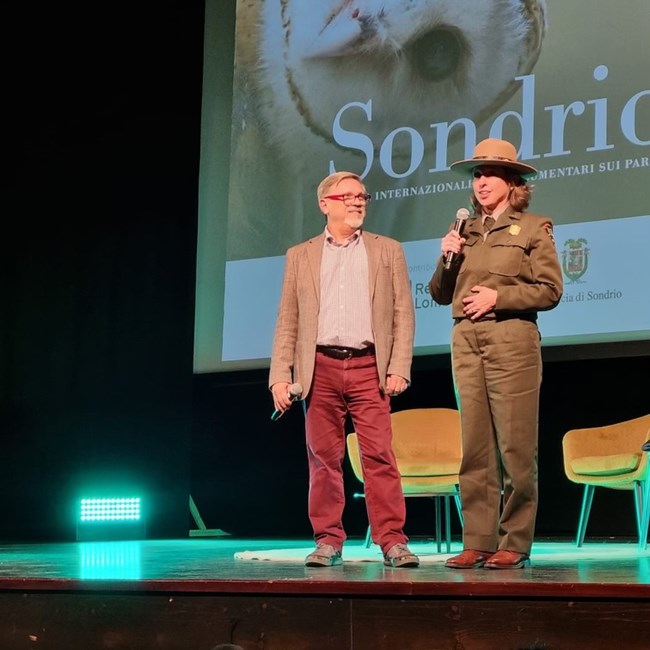 National Park Service Ranger Kerstin Burlingame talks about a film while on stage.