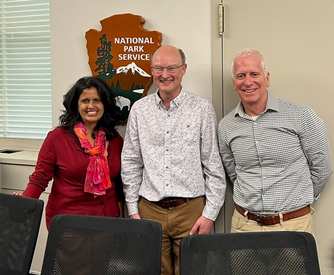 2023 UK NatTrust Rob Curry Rob Curry (center) with National Park Service employees after a meeting at the Main Interior building.
