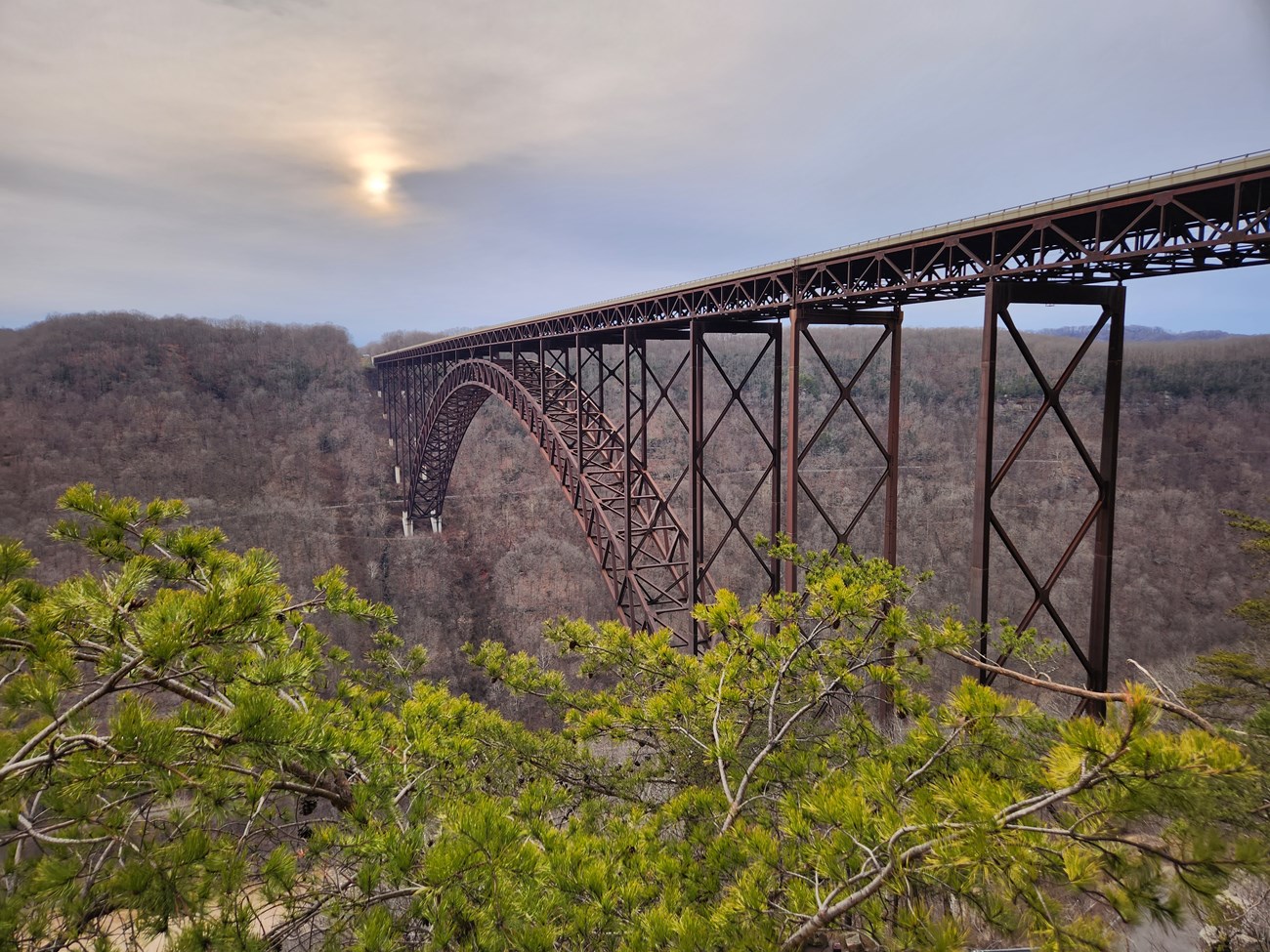 New River Gorge Bridge A view of the sun setting over the iconic New River Gorge bridge at sunset