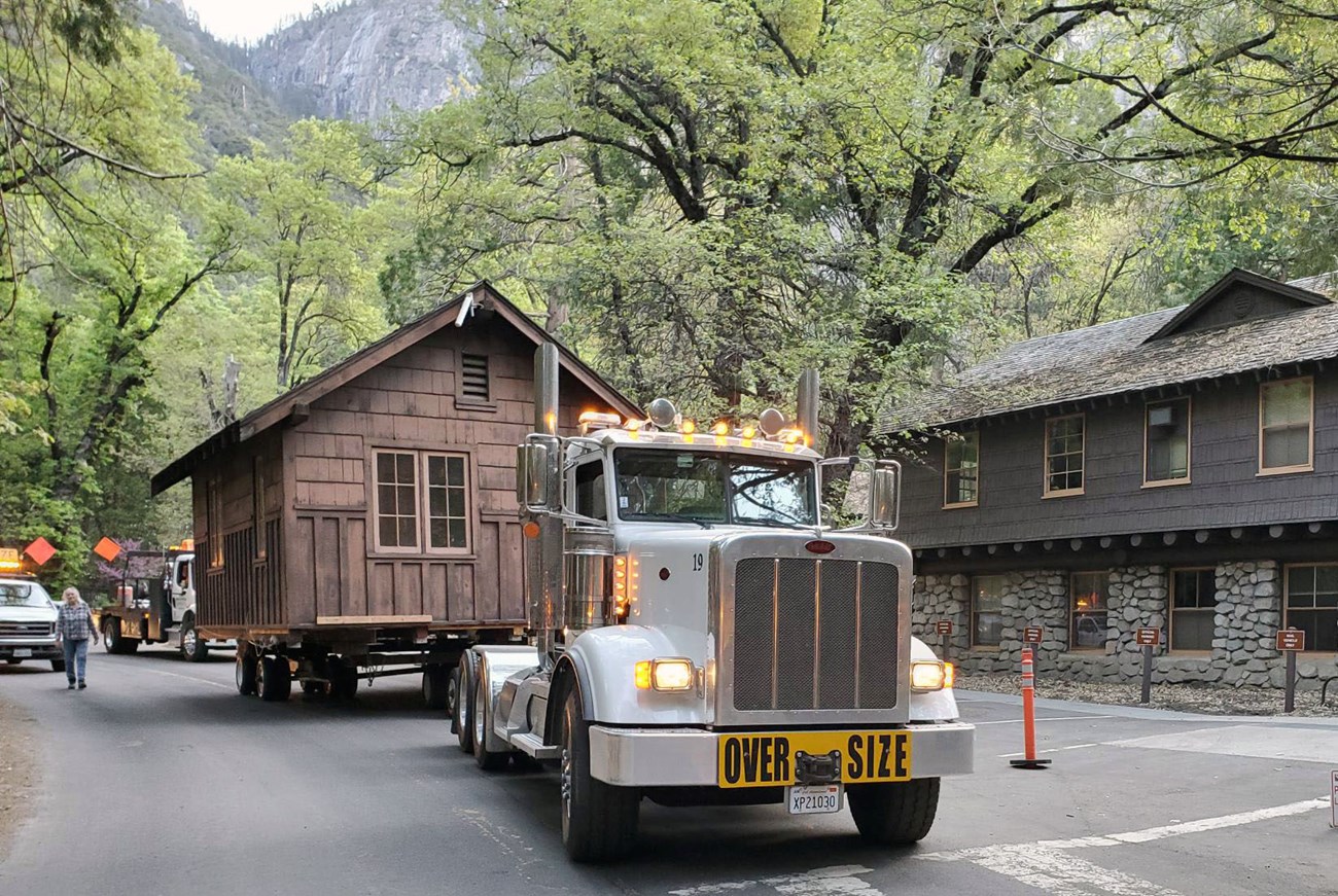 Moving the Wilson Cabin Tractor trailer drives wooden cabin through Yosemite Valley