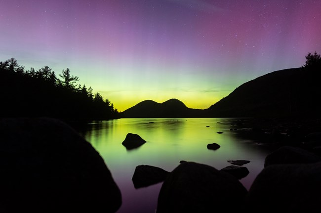 Aurora borealis lit up the sky over Jordan Pond on May 5th, 2024. Northern lights over Jordan Pond in May 2024.