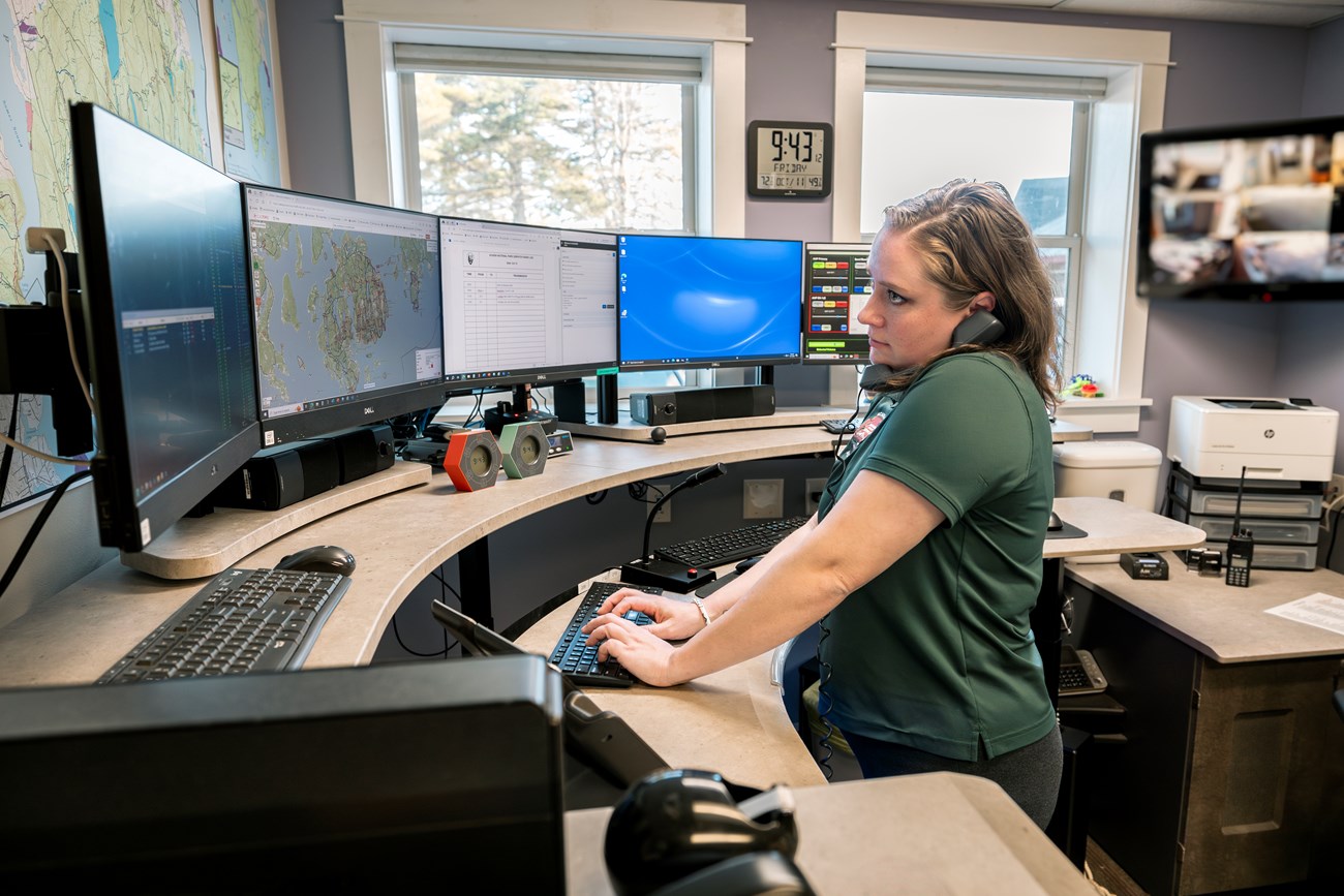 Brittany talks on the phone with EMS agencies when responding to an incoming 911 call. Woman talks on the phone with EMS agencies when responding to an incoming 911 call.