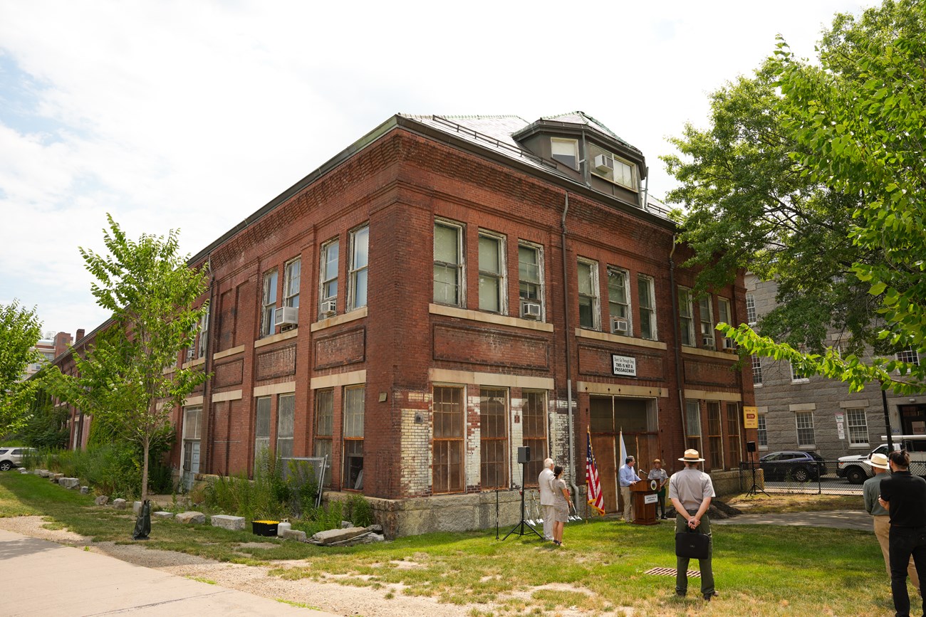 2024.07.17_BOST_NPS_CG-057 A three-story brick building, with the first two stories having paned windows and the third story as part of an arched roof.