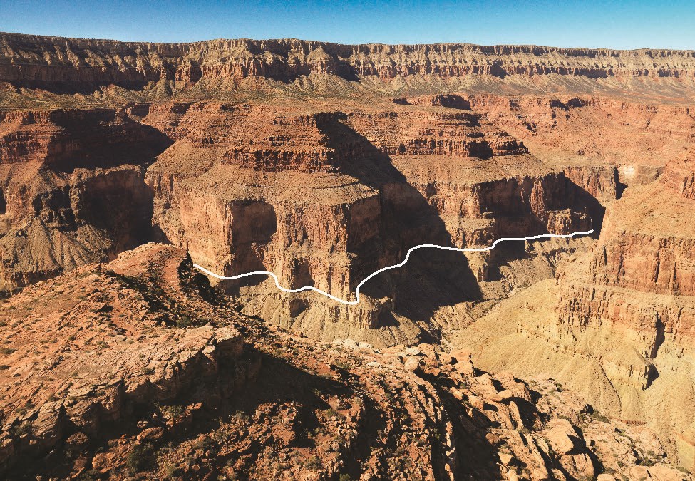 Photo of rocky cliffs and buttes with a line overlay highlighting a geologic contact.