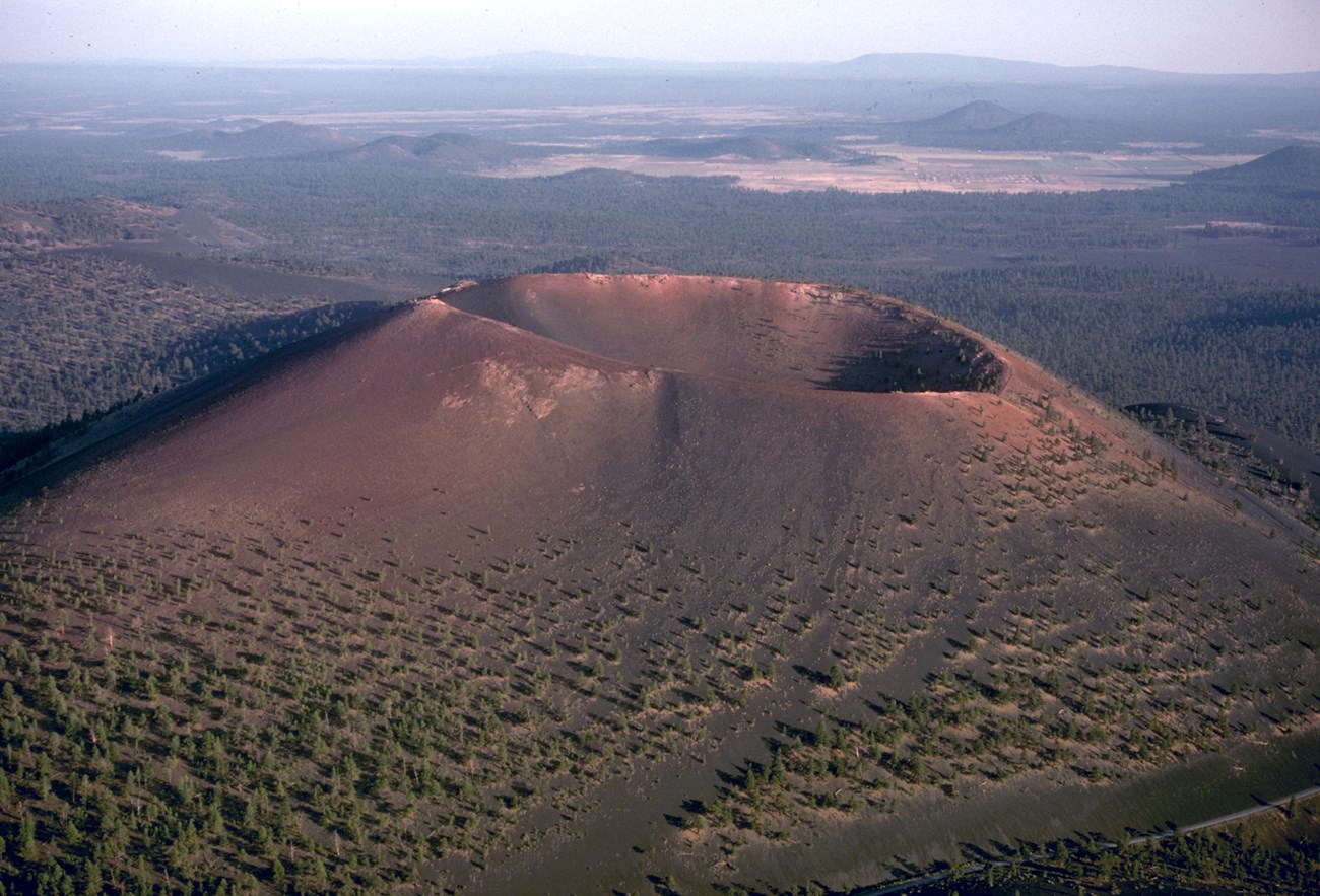 29991535786_d3de67b932_o aerial photo of a cinder cone with a large summit crater