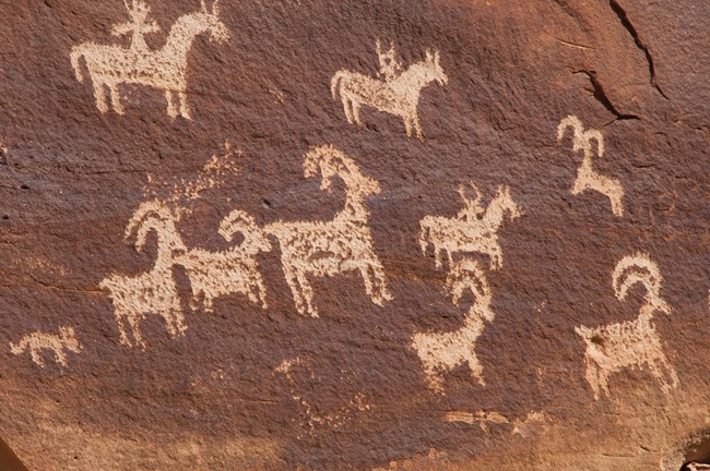 2d-264D66F9-155D-451F-670324BAA2C27173Original People hunt bighorn sheep from horseback at Arches National Park.