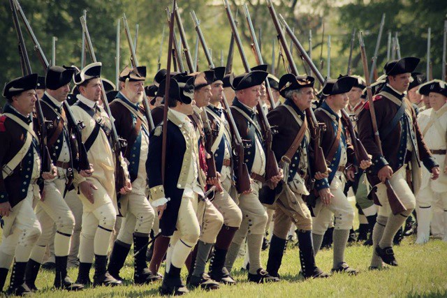 A well-ordered firing line of American soldiers, well equipped, in Revolutionary War uniforms. A well-ordered firing line of American soldiers, well equipped, in Revolutionary War uniforms.