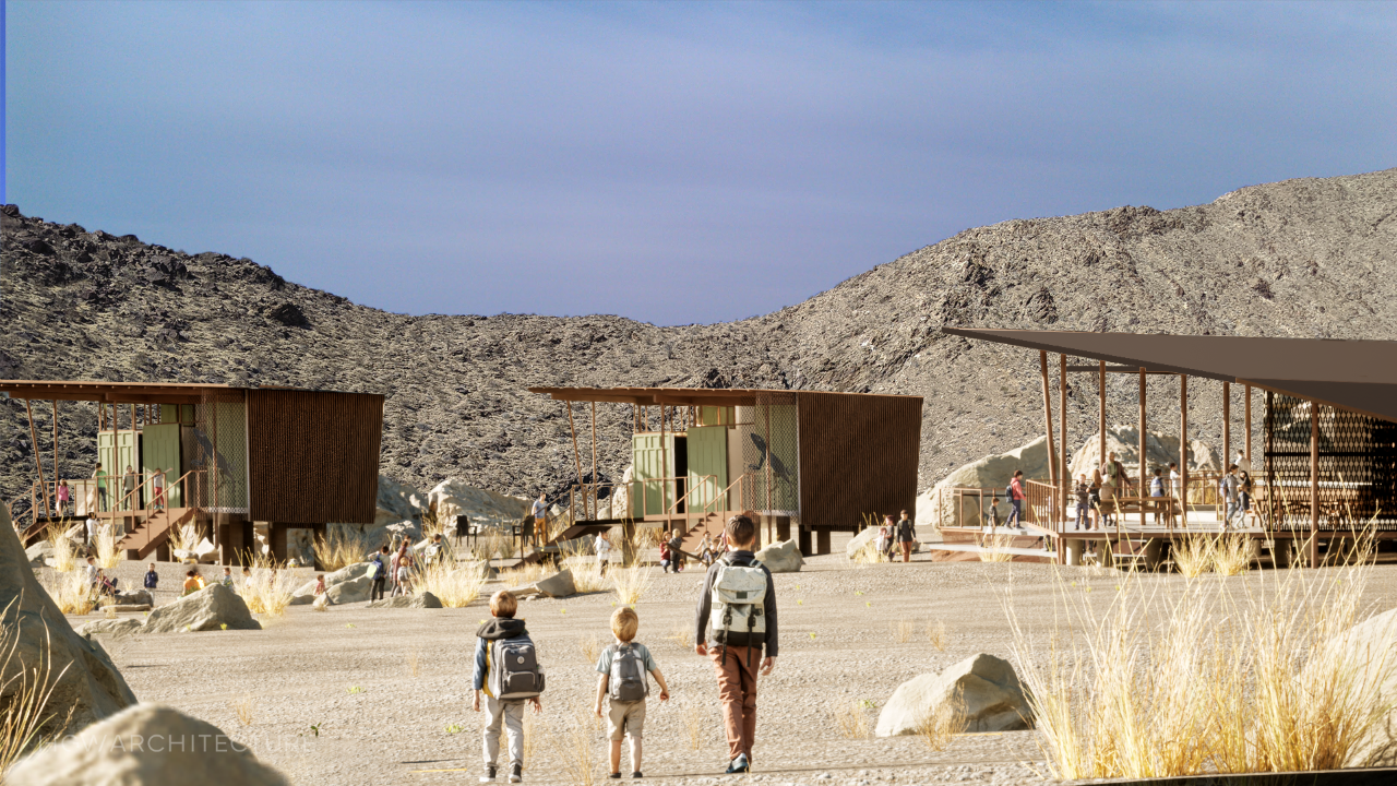 people walking towards buildings in the desert