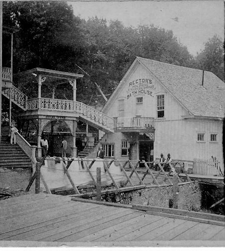 Black and white image of the Rectors bathhouse with bathers standing outside