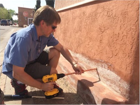 Figure 3. The sampling tool is advanced into the wall at suitable increments while holding the collection tube steady with the other hand.