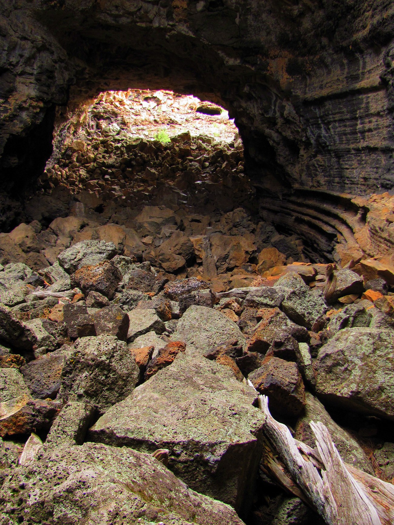 ELMA big skylight cave photo of a cave with block rock on the floor and ceiling