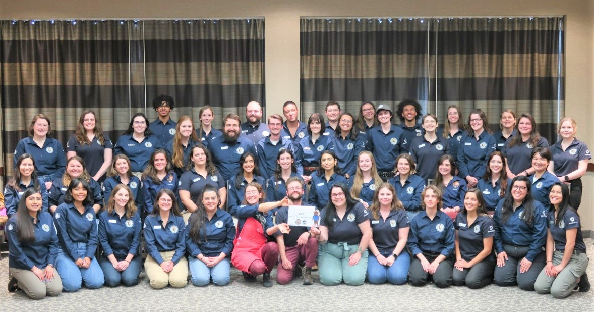 A group photo of Community Volunteer Ambassadors wearing navy uniforms at the annual National Early Service Training.