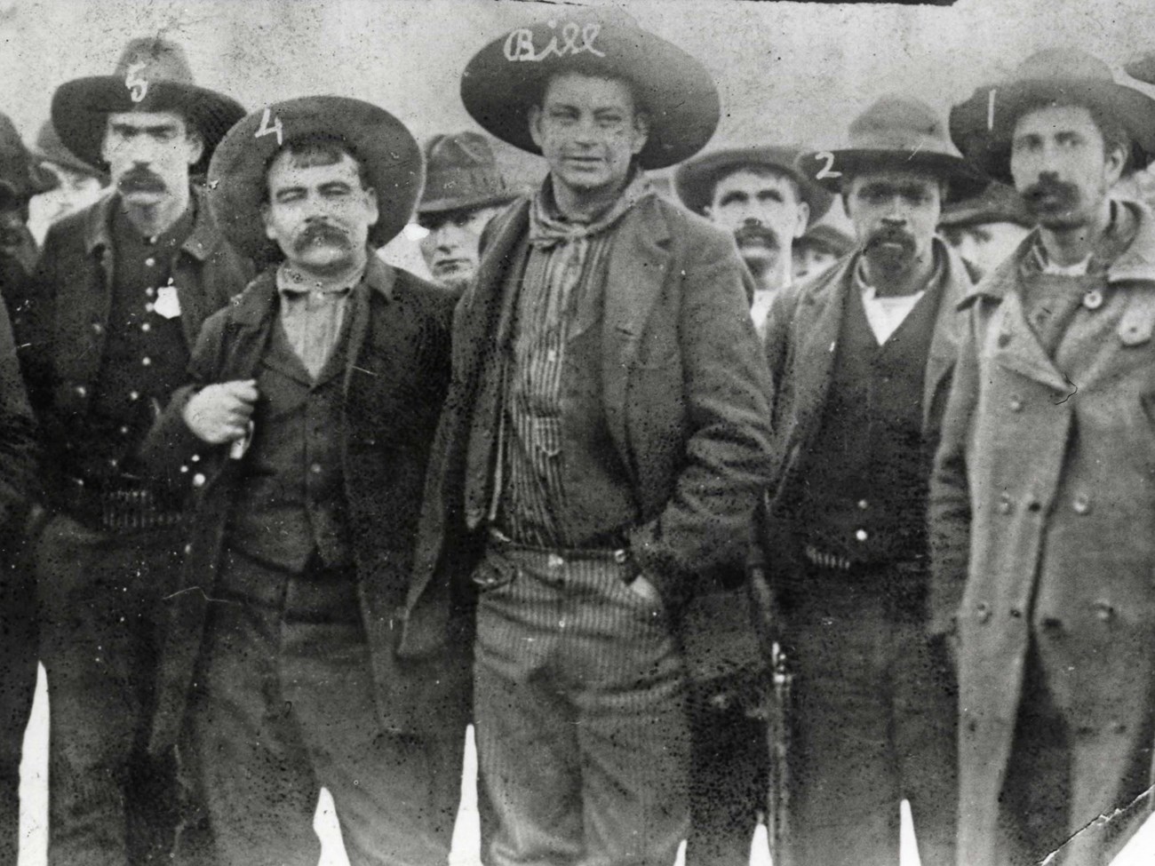 Capture of Crawford Goldsby, alias Cherokee Bill Black and white historic image of Cherokee Bill standing with deputy marshals that arrested him.