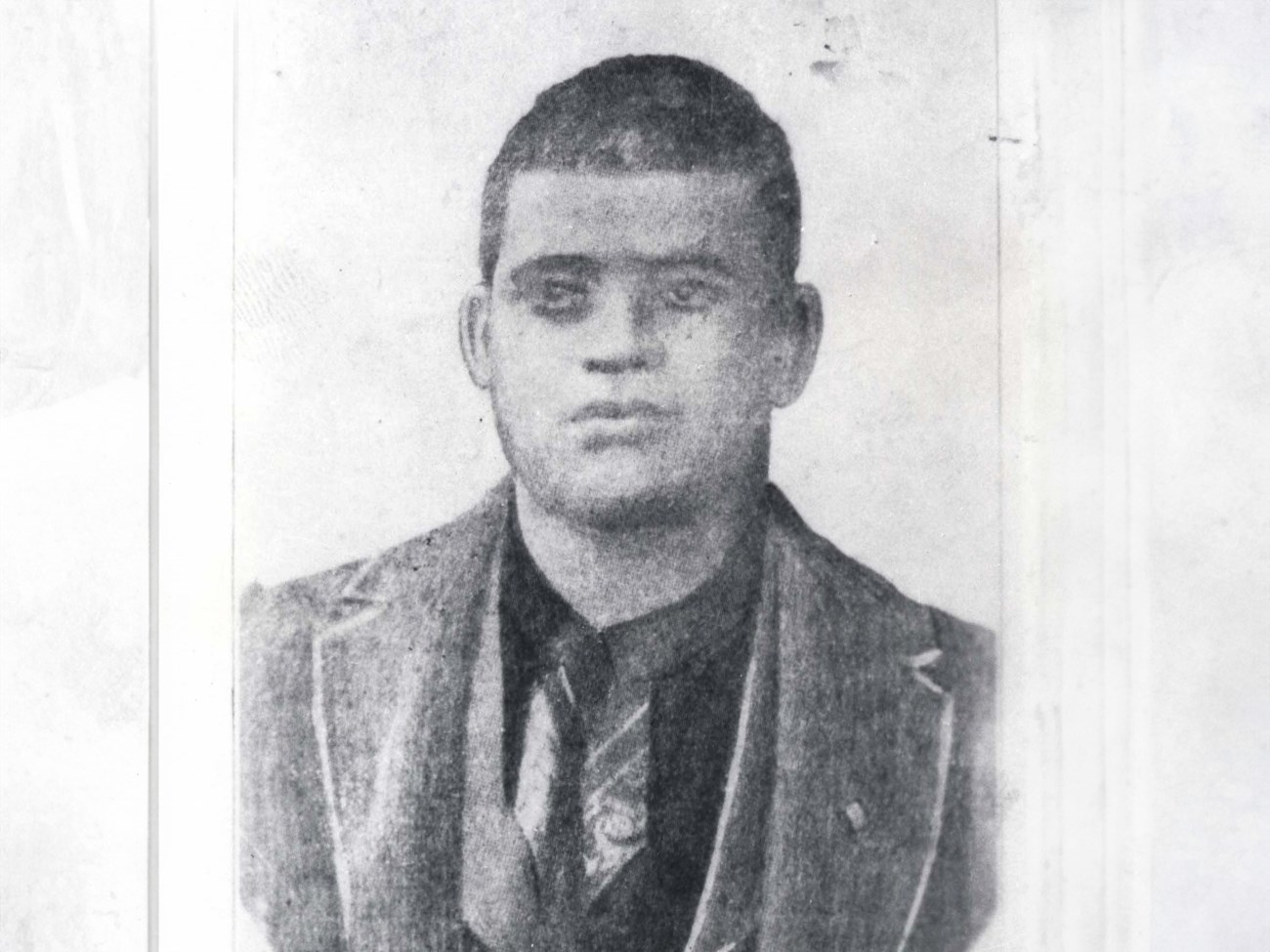 Last Known Photograph of Crawford Goldsby, alias Cherokee Bill Black and white historic portrait of Crawford Goldsby, a man with a serious face and short hair