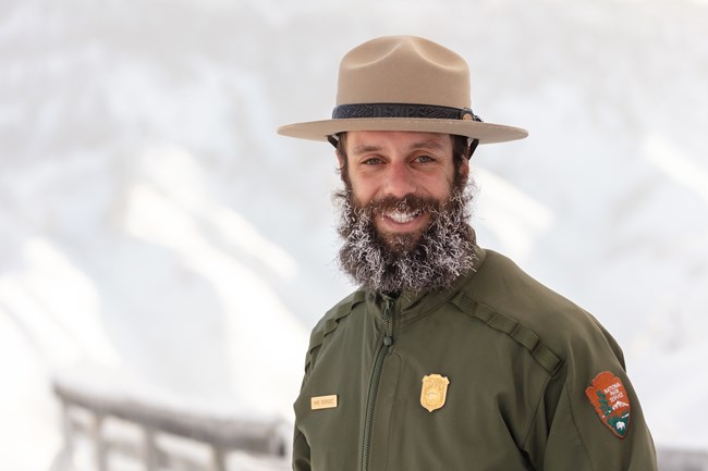 a park ranger with snow in his beard