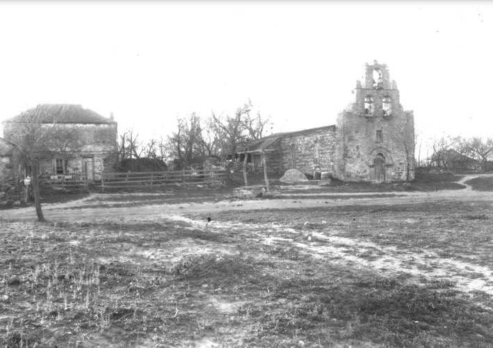 A black and white photo of a church and the connecting convento