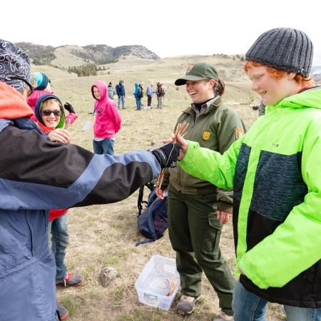 Educating Youth a park ranger teaching school kids how to play a game