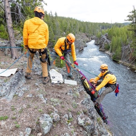 High-Angle Rescuing first responders rescuing a person from a cliffside