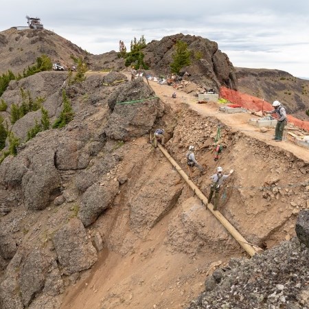 a crew doing construction on a high-elevation trail