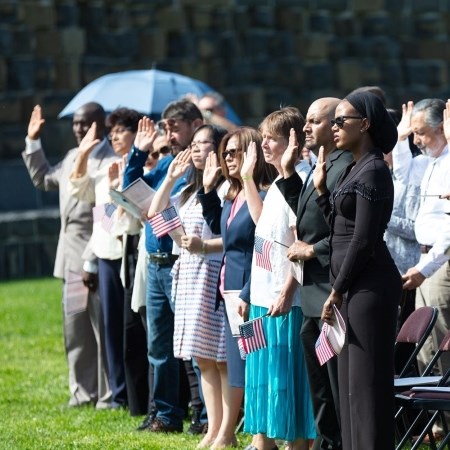 a group of people holding their hand in the air as they take an oath