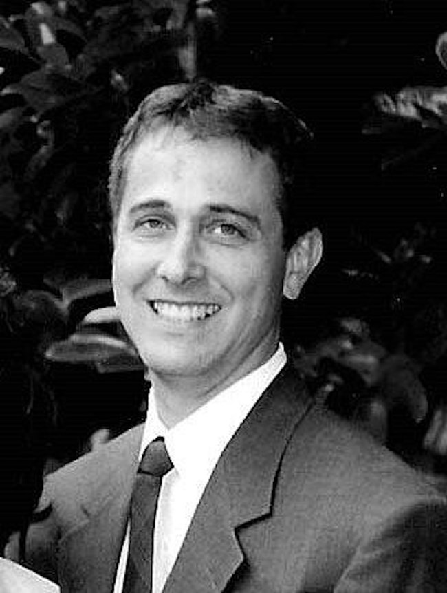 Patrick Sparks A black and white headshot photo of Patrick Sparks in a suit.