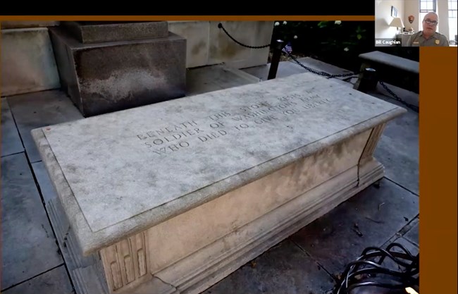 The lid of the sarcophagus is inscribed with the words, "Beneath this stone rests the soldier of Washington's army, who died to give you liberty." [Ranger Bill Caughlan, upper right hand corner.]