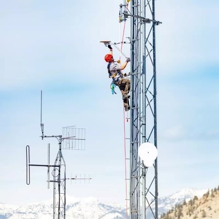 a person on a tall telecommunications tower