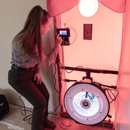 a park ranger operating a fan in a doorway