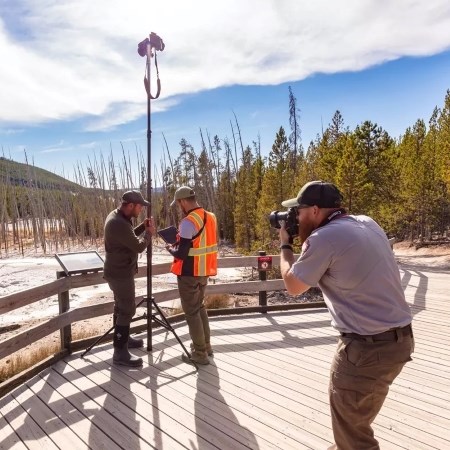 a park ranger photographing people