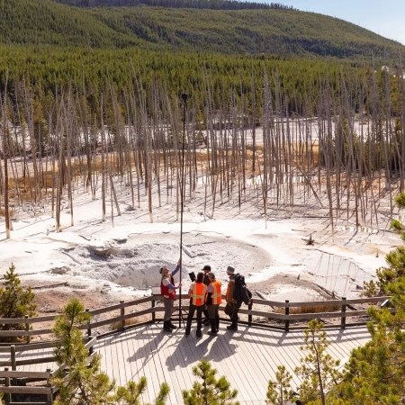Creating 3D Models Using Photogrammetry a group of people holding up a camera to photograph a thermal feature