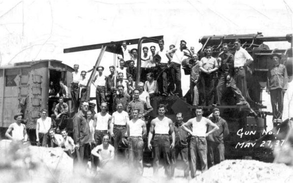 a group of young men stand in a group, looking at the camera