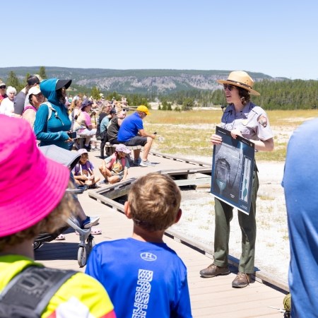a park ranger presenting to a crowd of people