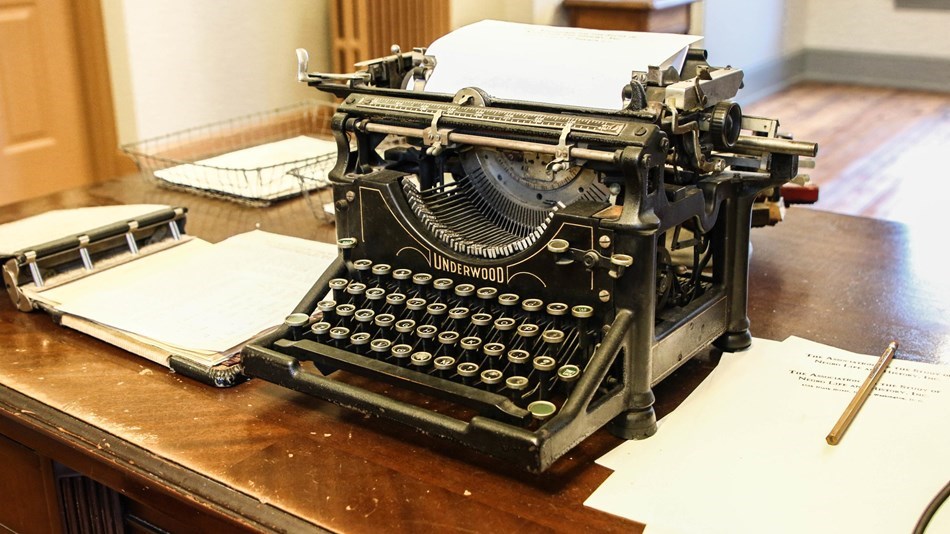 Typewriter and papers on a desk