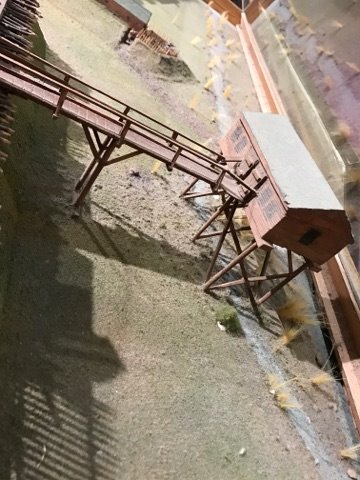 A wooden building on tall stilts. A bridge connects it to the fort. A stream runs underneath.