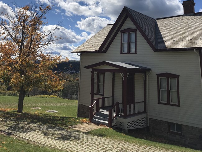 A beige house (the Unger House) with reddish-brown trim. A beige house (the Unger farmhouse) with reddish-brown trim.