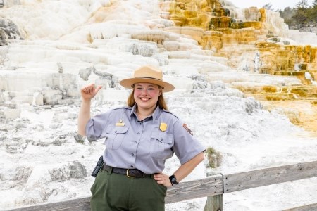 Follow the Beaten Path a park ranger in front of a thermal feature