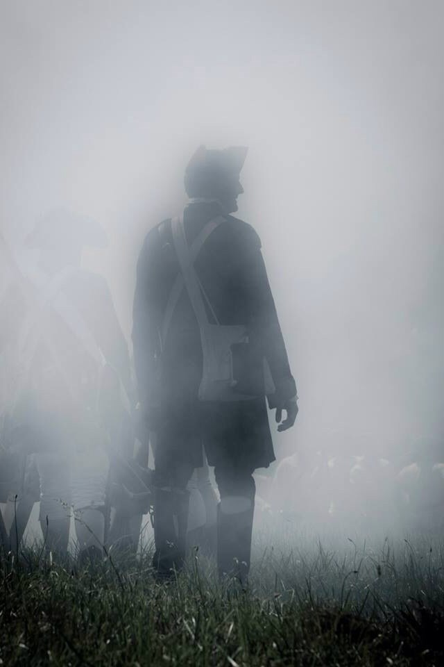 A Continental Army soldier stands among comrades in a thick fog of smoke. Fog of War: LGBTQIA servicemembers have served in the American armed forces from the beginning. A Continental Army soldier stands among comrades in a thick fog of smoke.