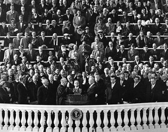 A black and white image of Dwight Eisenhower taking the oath of office on January 20, 1953