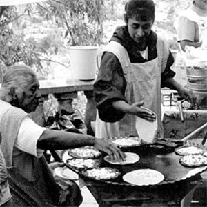 a woman serving tortillas