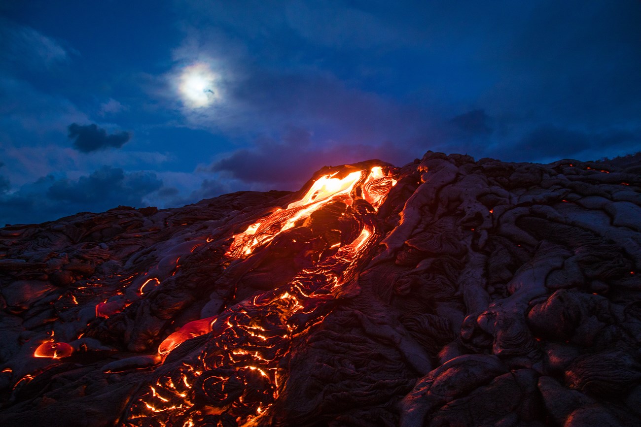 molten lava flowing down a hillside