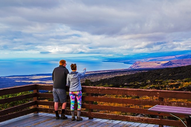 Visitors enjoying a view of the coastline from an overlook.