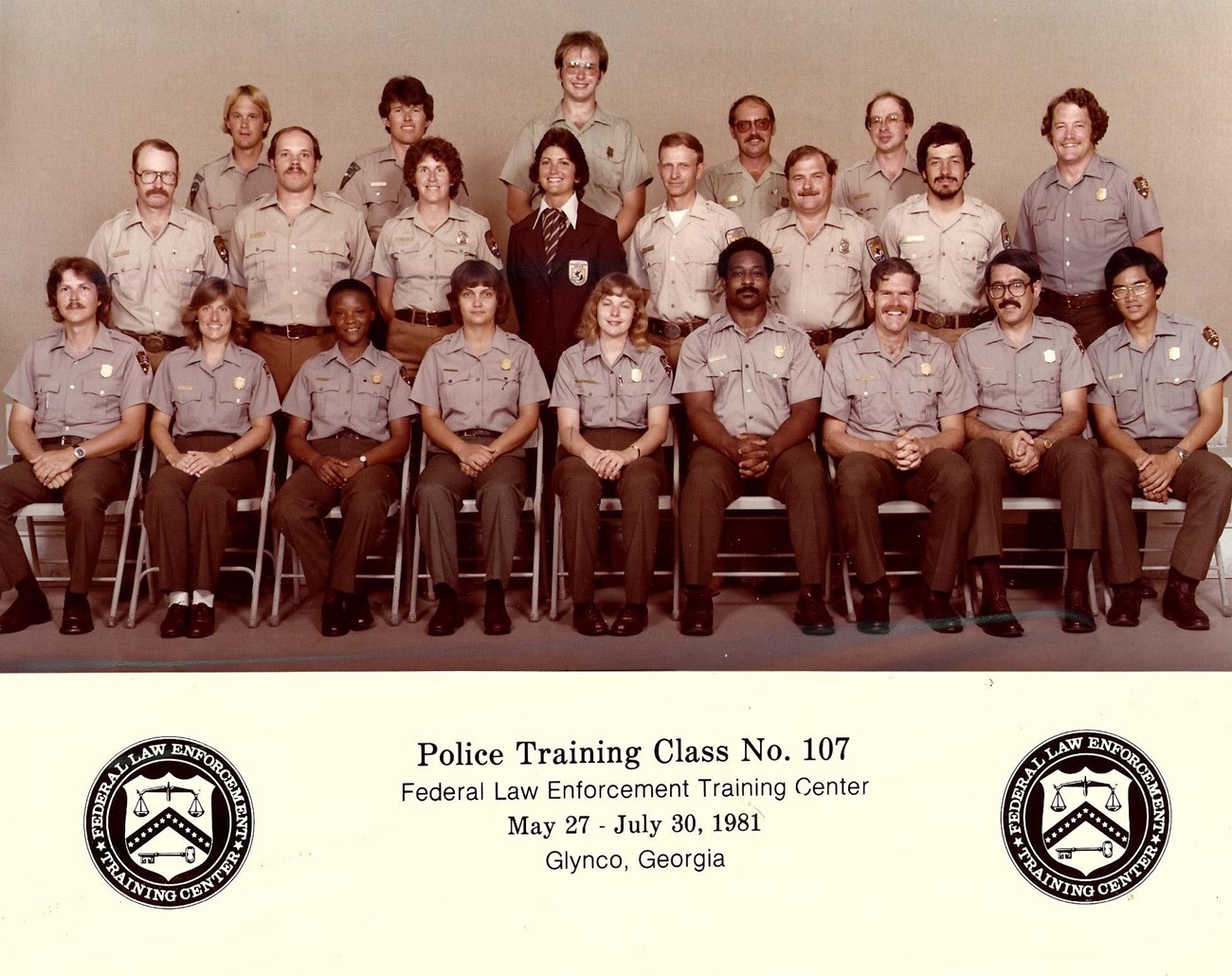 Police Training Class, 1981 NPS rangers in uniform pose for a group photo. One woman wears a US Fish and Wildlife Service jacket.
